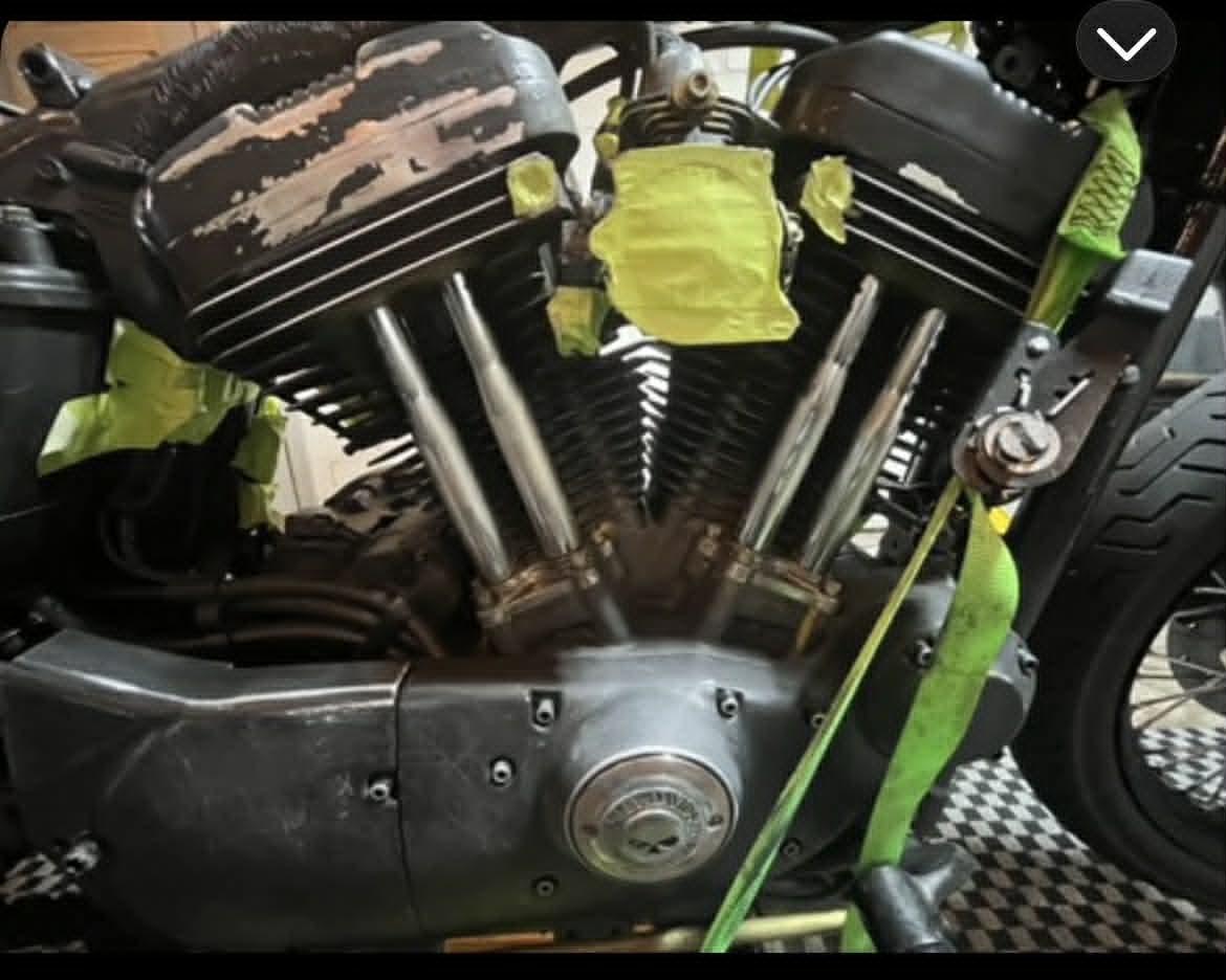 V-twin engine pre-paint — chipped rocker covers, raw silver pushrod tubes