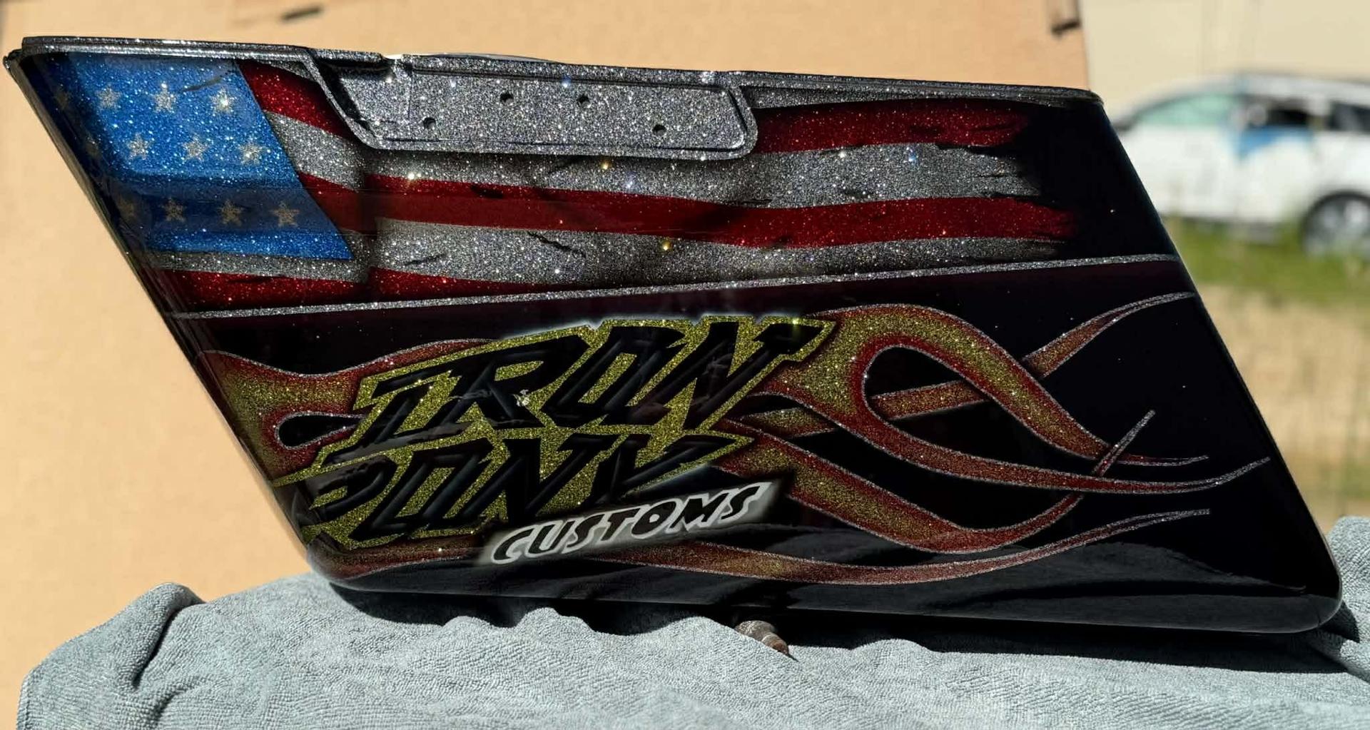 Airbrushed "Iron Pony Customs" metal sign with flame scrollwork over an American flag