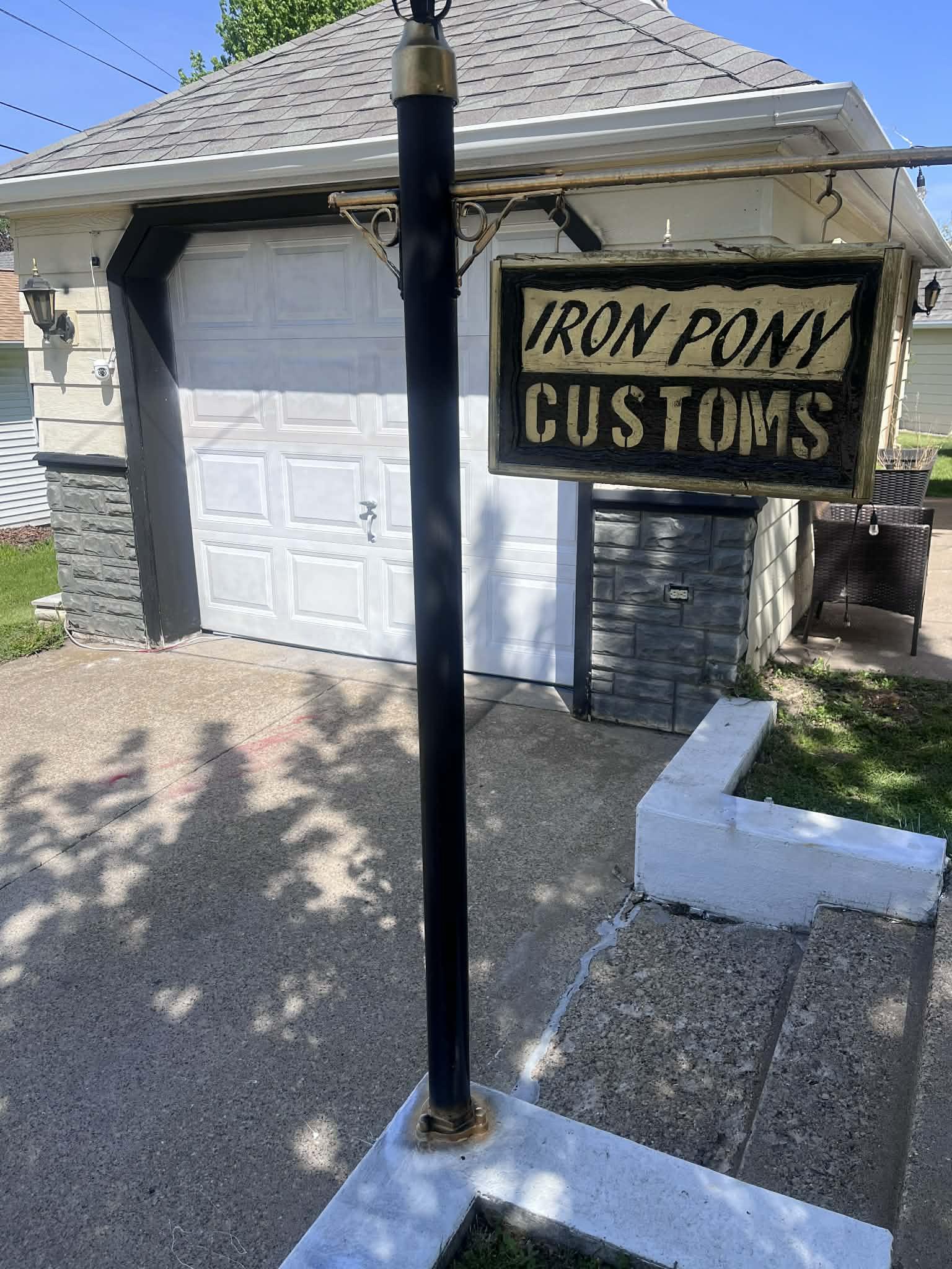 Iron Pony Customs hanging shop sign at the garage